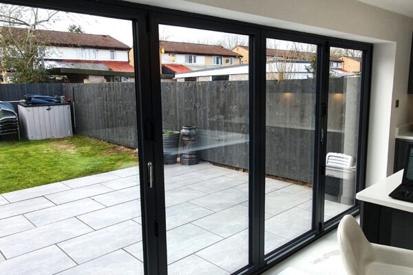 View-through-Aluminium-Bi-folding-doors-to-new-porcalin-patio-scaled