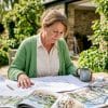 Woman reviewing orangery home plans at kitchen table