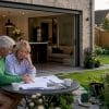 Rear kitchen extension with garden view and couple reviewing plans
