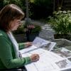 Woman reviewing hup extension plans at kitchen table
