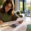Homeowner comparing extension quotes at kitchen table