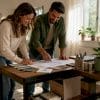 Couple reviewing garage conversion plans in living space
