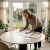 Woman assessing value of home extension