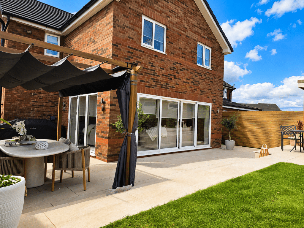 Completed two-storey rear house extension with white uPVC sliding patio doors installed by Complete Property Solutions in Newton-le-Willows.
