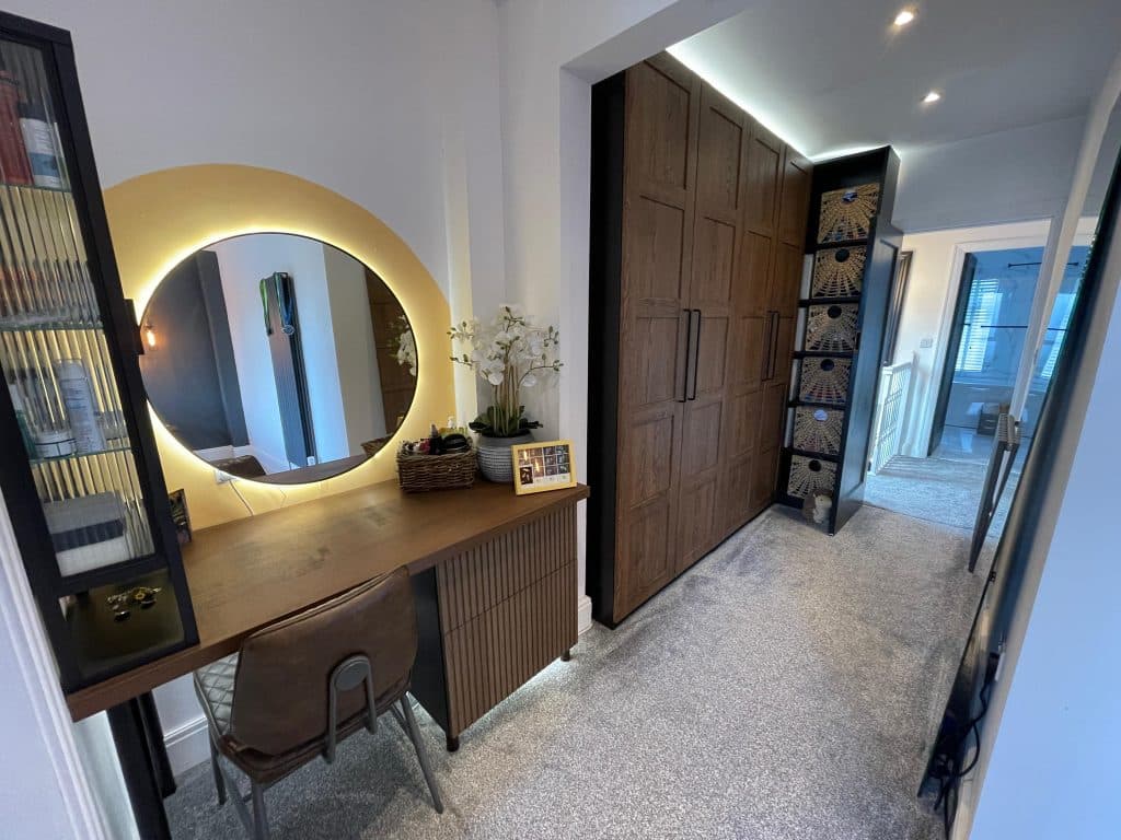 Modern dressing room leading into a completed bathroom extension in Penketh.