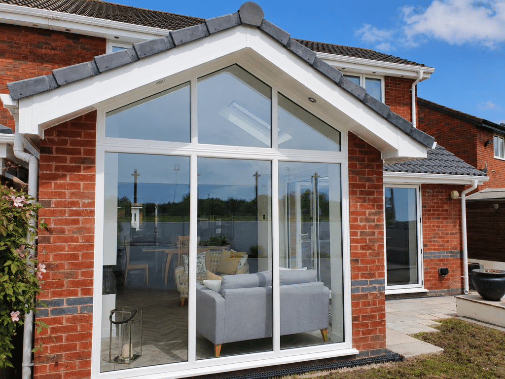 Single-storey brick rear extension in St Helens with a tiled roof, rooflight and large white-framed patio doors.