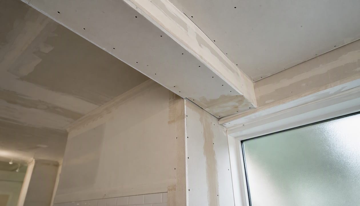 Fire-protected plasterboard boxing on steel beam