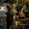 Homeowner checking sewer plans at construction site
