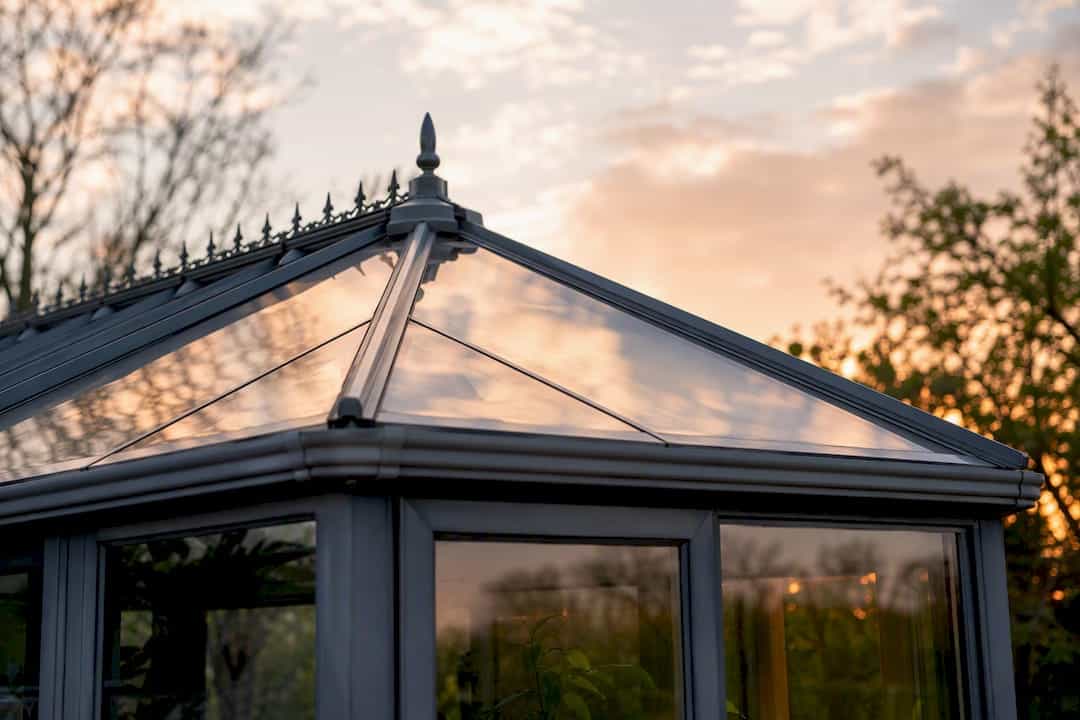 Glass conservatory roof panels reflect sky