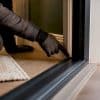 Installer checking a door threshold seal