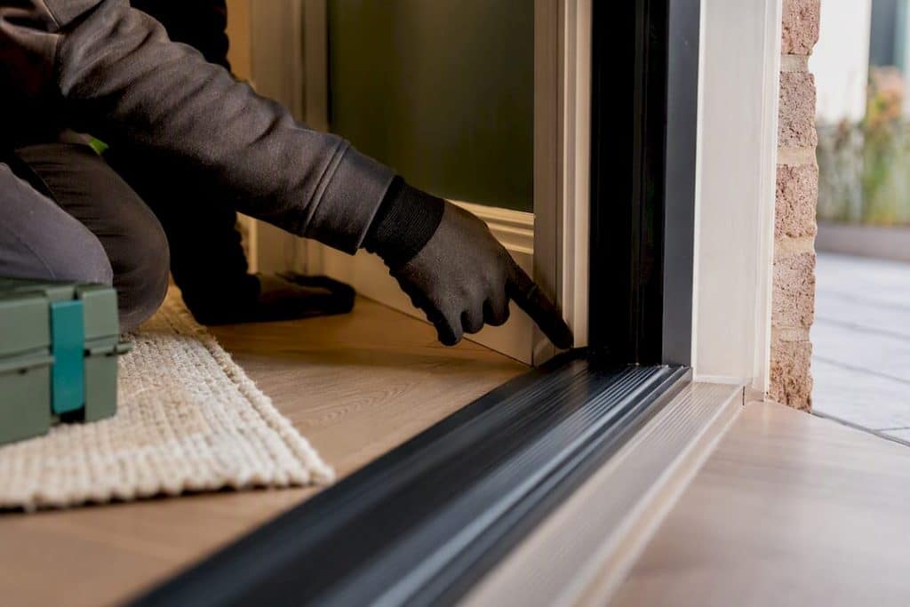 Installer checking a door threshold seal