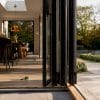 Partially opened bifold doors in home extension