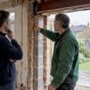 Homeowner discussing extension design options on site