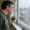 Homeowner examining a misted double-glazed window