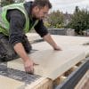 Builder laying insulation on an extension roof
