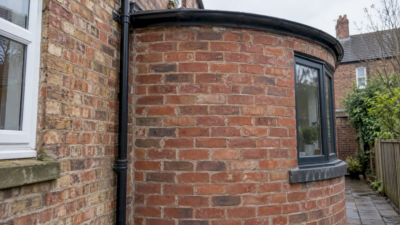 Curved brick detail beside a period home