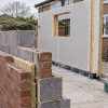 Brick and modular extension wall systems on site